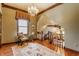 Attic landing featuring wood floors, chandelier, and window with decorative valance, and a stairway at 11705 N Shelby 700 W, New Palestine, IN 46163