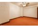 Unfinished basement with neutral walls, orange carpet, and ceiling fan offers a versatile space at 11705 N Shelby 700 W, New Palestine, IN 46163