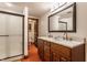 Bathroom featuring double sinks, wood cabinets, and a walk-in shower at 11705 N Shelby 700 W, New Palestine, IN 46163