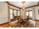 Charming dining room with a wooden table, decorative rug, and natural light pouring through surrounding windows at 11705 N Shelby 700 W, New Palestine, IN 46163
