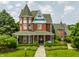 Beautiful Victorian home featuring manicured landscaping, brick facade, and charming front porch with swing at 11705 N Shelby 700 W, New Palestine, IN 46163