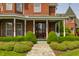 Charming covered porch with a swing, beautiful landscaping, and stone pathway at 11705 N Shelby 700 W, New Palestine, IN 46163