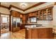 Well-equipped kitchen featuring wood cabinets, stainless steel appliances, and a view into the breakfast nook at 11705 N Shelby 700 W, New Palestine, IN 46163