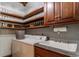 Functional laundry room with ample storage, including shelving with glass jars, a utility sink, and a washer/dryer at 11705 N Shelby 700 W, New Palestine, IN 46163
