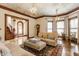 Charming living room with hardwood floors, ornate ceiling, and a stained glass window at 11705 N Shelby 700 W, New Palestine, IN 46163