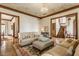 Inviting living room showcasing detailed ceiling, hardwood floors, staircase, and an abundance of natural light at 11705 N Shelby 700 W, New Palestine, IN 46163