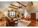 Spacious living room with exposed beam ceiling, hardwood floors, a ceiling fan, and comfortable seating at 11705 N Shelby 700 W, New Palestine, IN 46163