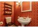 Classic powder room featuring decorative wallpaper, pedestal sink, and charming ornamental shelving and fixtures at 11705 N Shelby 700 W, New Palestine, IN 46163