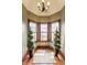 Cozy sitting area with large windows, decorative plants, hardwood floors, and neutral color scheme at 11705 N Shelby 700 W, New Palestine, IN 46163