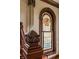Staircase featuring custom carved details and a stained glass window at 11705 N Shelby 700 W, New Palestine, IN 46163