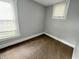 Cozy bedroom with carpeted floors and ample natural light from two windows at 1247 Wright St, Indianapolis, IN 46203