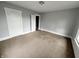 An empty bedroom with neutral carpet, grey walls and white trim and doors at 1247 Wright St, Indianapolis, IN 46203