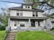 Classic two-story home showcasing its inviting front porch and well-maintained lawn at 1247 Wright St, Indianapolis, IN 46203