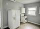 Functional kitchen with a white refrigerator and stove, complemented by upper cabinets at 1247 Wright St, Indianapolis, IN 46203