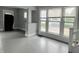Sun-filled living area features neutral paint, multiple windows, and a staircase at 1247 Wright St, Indianapolis, IN 46203