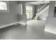 Neutral living room features freshly painted walls, a staircase, and great natural light at 1247 Wright St, Indianapolis, IN 46203