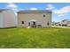Backyard with lawn, patio, dining set, grill and view of other houses in the community at 13887 N Hawkers Hill Dr, Camby, IN 46113