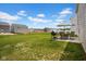 Green backyard featuring a grill, table, umbrella and view of adjacent properties at 13887 N Hawkers Hill Dr, Camby, IN 46113