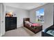 Cozy bedroom with a twin bed, carpet, and large window offering a view of the outdoors at 13887 N Hawkers Hill Dr, Camby, IN 46113