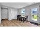 Bright dining room features wood floors, a dining table set, and an exterior view at 13887 N Hawkers Hill Dr, Camby, IN 46113