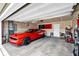 Attached garage featuring a red sports car, white walls, overhead storage and epoxy flooring at 13887 N Hawkers Hill Dr, Camby, IN 46113