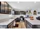 A modern kitchen featuring dark cabinets, granite countertops, and stainless steel appliances at 13887 N Hawkers Hill Dr, Camby, IN 46113