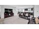 View of a spacious living room showcasing an open-concept layout with leather furniture and a flat-screen TV at 13887 N Hawkers Hill Dr, Camby, IN 46113