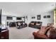 View of an open concept living area and kitchen, connected by a plush carpet and comfortable furniture at 13887 N Hawkers Hill Dr, Camby, IN 46113