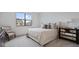 Bright, minimalist bedroom featuring a large window, neutral tones, and comfortable furnishings at 14866 E Keenan Cir # Lot 38, Westfield, IN 46074