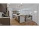 Open-concept kitchen with stainless steel appliances and a center island, flowing into the dining and living areas at 14866 E Keenan Cir # Lot 38, Westfield, IN 46074
