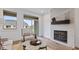 Cozy living room features a fireplace, large windows, and stylish decor for comfortable living at 14866 E Keenan Cir # Lot 38, Westfield, IN 46074