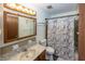 Bathroom featuring wood cabinets, vanity and a shower and tub combo at 1602 Queensbridge Sq # 7, Indianapolis, IN 46219
