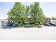 A traditional brick building with mature trees, black shutters, and ample parking at 1602 Queensbridge Sq # 7, Indianapolis, IN 46219