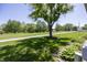 Manicured front lawn with lush greenery, mature trees, and scenic neighborhood views at 1602 Queensbridge Sq # 7, Indianapolis, IN 46219