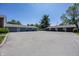 Exterior view of garages behind a community featuring several parking spots at 1602 Queensbridge Sq # 7, Indianapolis, IN 46219