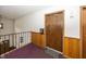 A common hallway with unit doors, wood panels, carpeting, and lighting at 1602 Queensbridge Sq # 7, Indianapolis, IN 46219