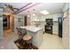 Bright kitchen featuring white cabinets and dark appliances with bar seating at 1602 Queensbridge Sq # 7, Indianapolis, IN 46219