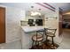 Cozy kitchen with stainless steel appliances, breakfast bar and white cabinets at 1602 Queensbridge Sq # 7, Indianapolis, IN 46219