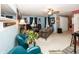 Open living room with two accent chairs, ceiling fan, and a large mirror at 1602 Queensbridge Sq # 7, Indianapolis, IN 46219