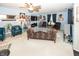 Comfortable living room with ample seating, ceiling fan, and TV with a fireplace at 1602 Queensbridge Sq # 7, Indianapolis, IN 46219