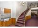 Grand lobby staircase with a chandelier, a mail center, and carpeted steps at 1602 Queensbridge Sq # 7, Indianapolis, IN 46219