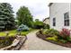Backyard garden with pond, gravel path, and lush garden beds; side view of the house at 16126 Etna Green, Westfield, IN 46074