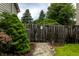 Rustic backyard with wooden fence and small gravel path, enhanced by beautiful trees and shrubs at 16126 Etna Green, Westfield, IN 46074