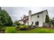The home's well-manicured backyard includes mature plantings, a patio, and landscaped garden beds at 16126 Etna Green, Westfield, IN 46074