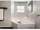 Bathroom featuring a corner soaking tub, decorative artwork, and ample natural light at 16126 Etna Green, Westfield, IN 46074