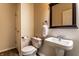 Well-lit half bathroom featuring a pedestal sink, toilet, and decorative mirror at 16126 Etna Green, Westfield, IN 46074