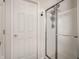 Bathroom featuring a walk-in shower with glass doors next to a white door at 16126 Etna Green, Westfield, IN 46074