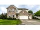 Beautifully maintained two-story home with a brick and siding exterior, lush lawn, and an attached garage at 16126 Etna Green, Westfield, IN 46074