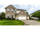 Charming two-story home with a brick and siding exterior, well-manicured lawn, and three-car garage at 16126 Etna Green, Westfield, IN 46074