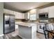 Bright kitchen featuring white cabinets, stainless steel refrigerator, and a kitchen island at 16126 Etna Green, Westfield, IN 46074